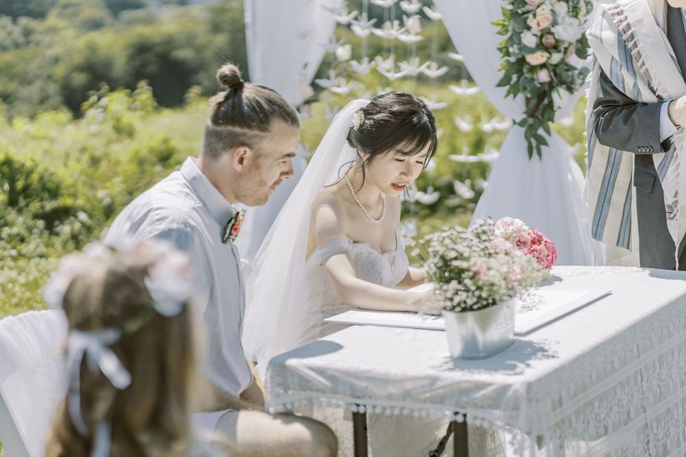 Wedding ceremony decor featuring vintage white settee against scenic natural backdrop.