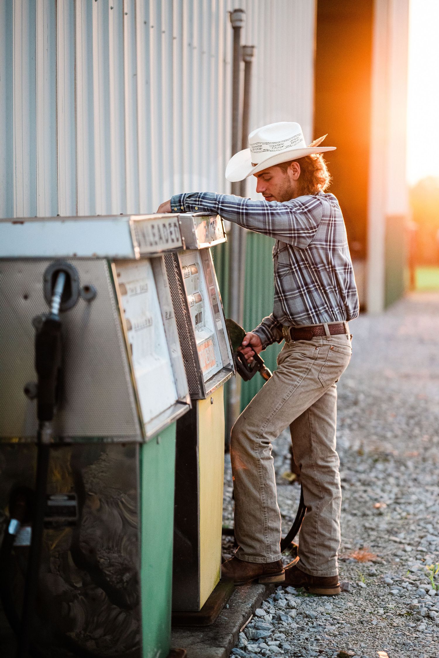 Rural mailboxes stand in a row at sunset with warm golden light filtering through.