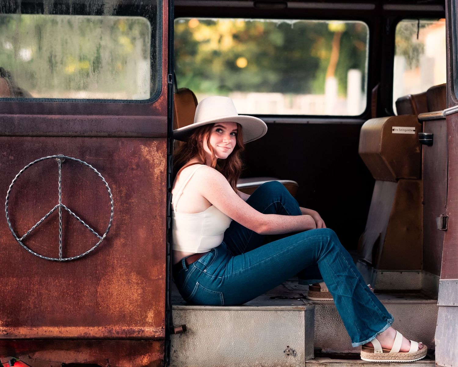 Vintage-style photos inside rustic vehicle interior with peace symbol detail.