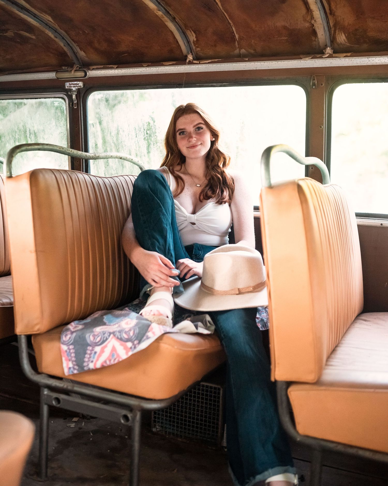 Interior of classic car with tan leather bench seats.