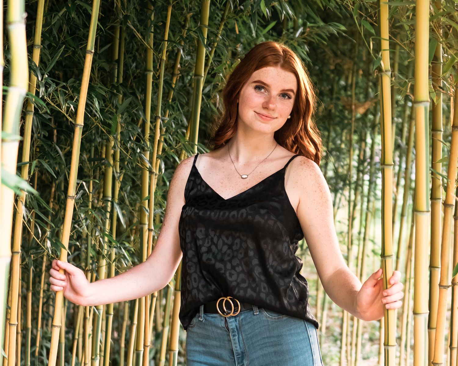 Outdoor fashion photoshoot in bamboo forest setting.