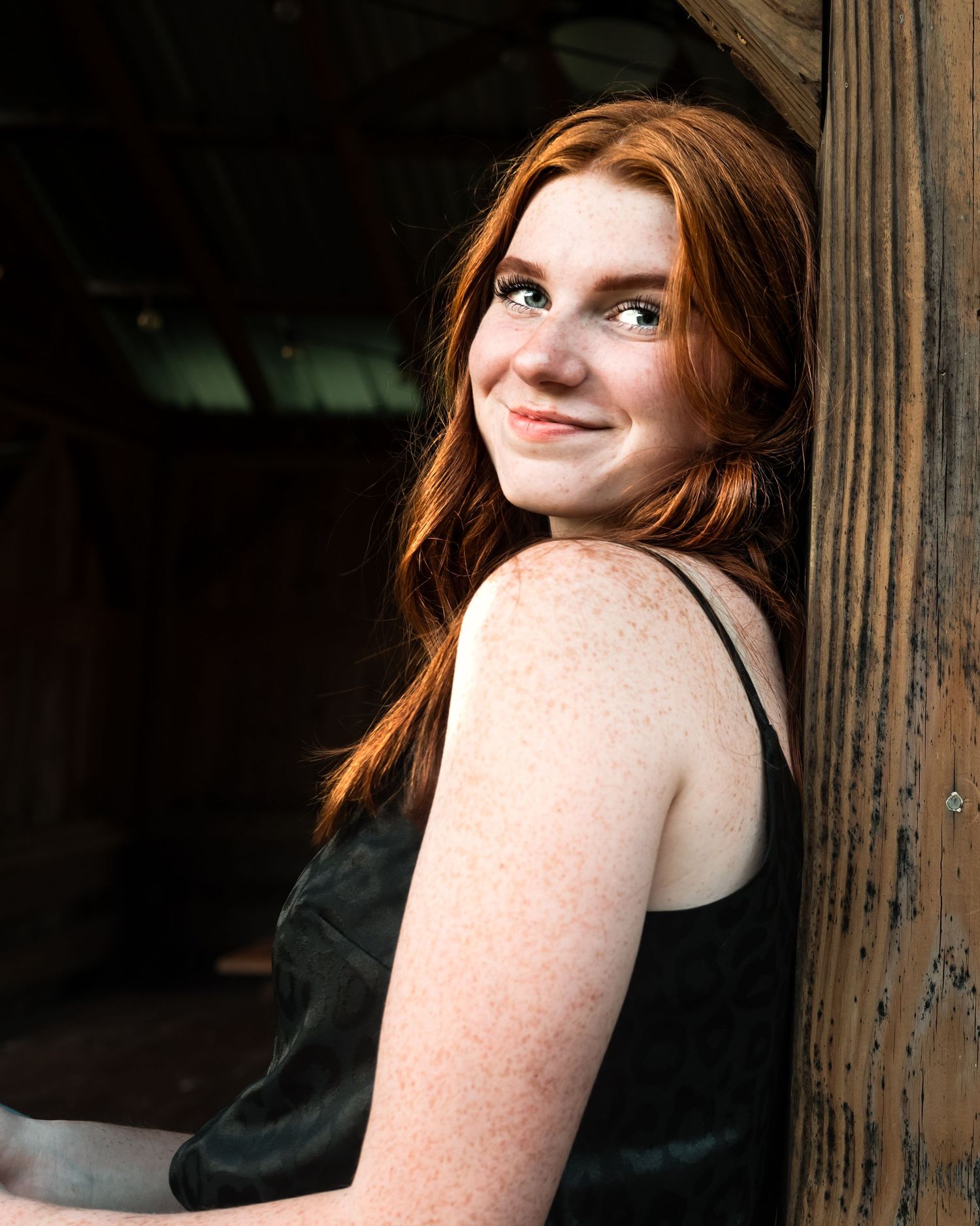 Artistic portrait series against rustic wooden post background.