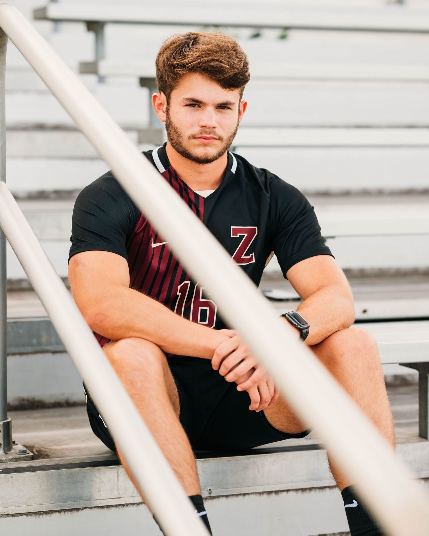 Athletic wear photography on white bleachers with diagonal lines.