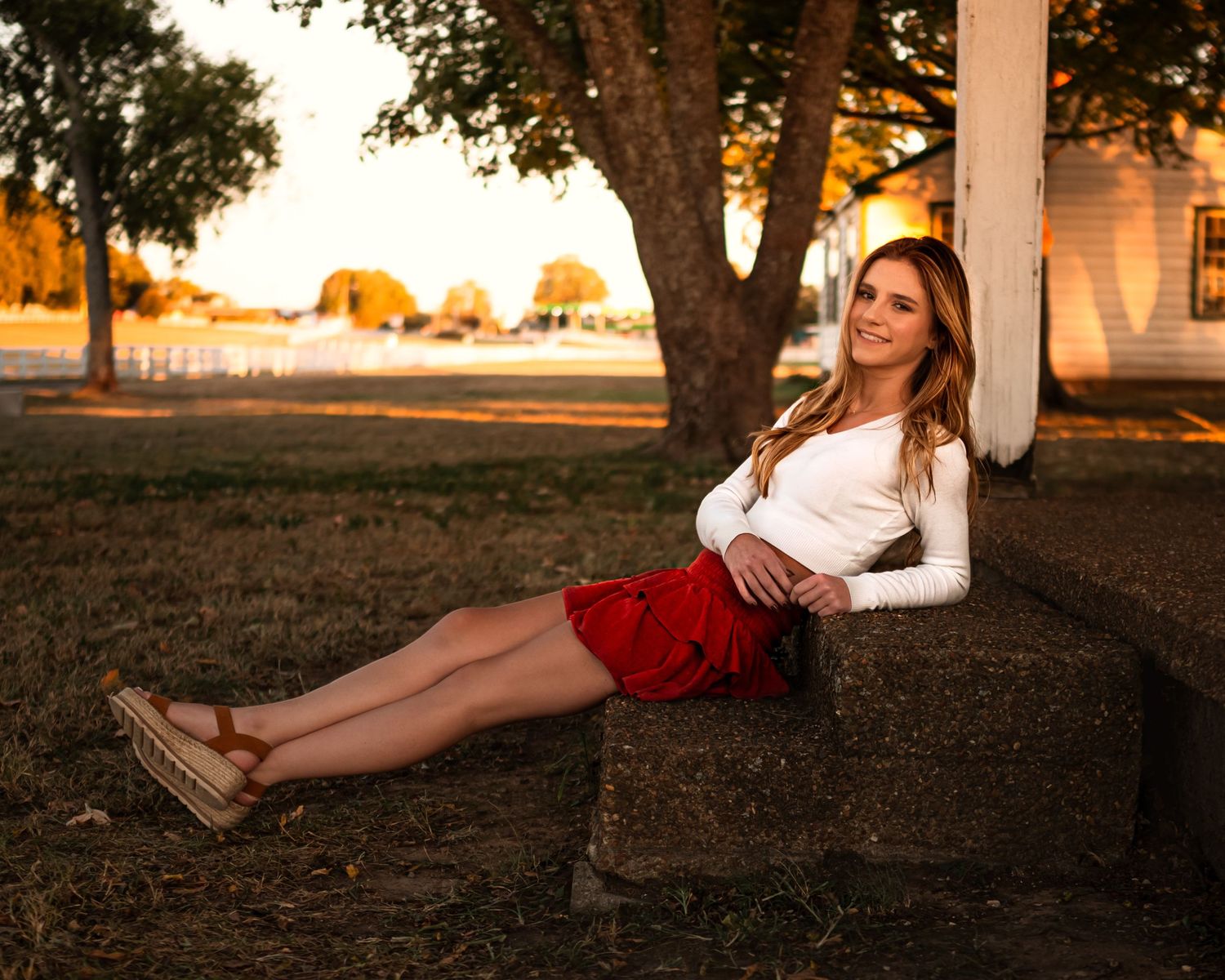 Outdoor portrait session during golden hour with trees in background.