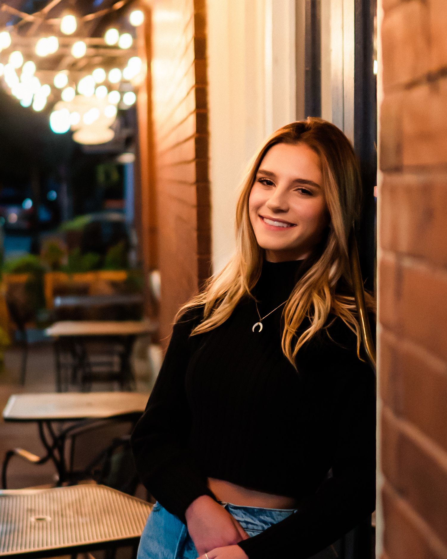 Nighttime portrait session with warm ambient lighting and bokeh effects.