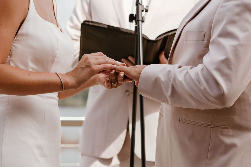 A couple exchanges rings during an intimate wedding ceremony moment.