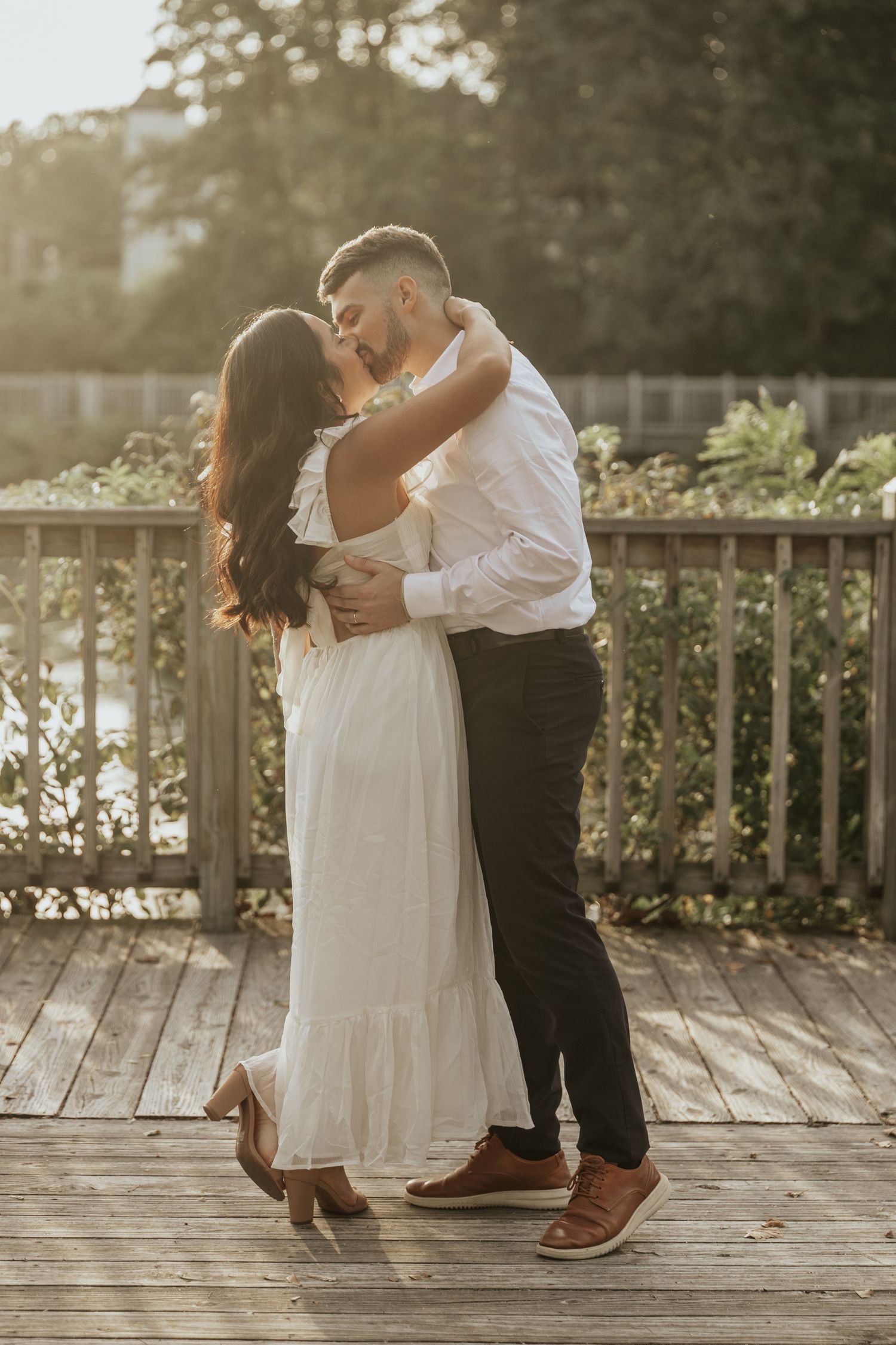 Close up of couple sharing intimate laugh while touching foreheads outdoors.