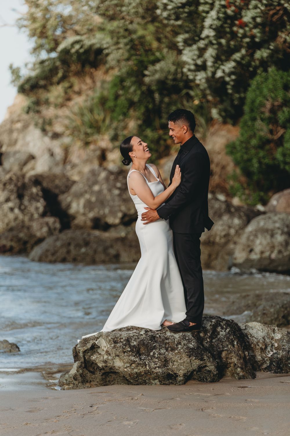 Ash and Tyran on the beach at whangapoua on their wedding day