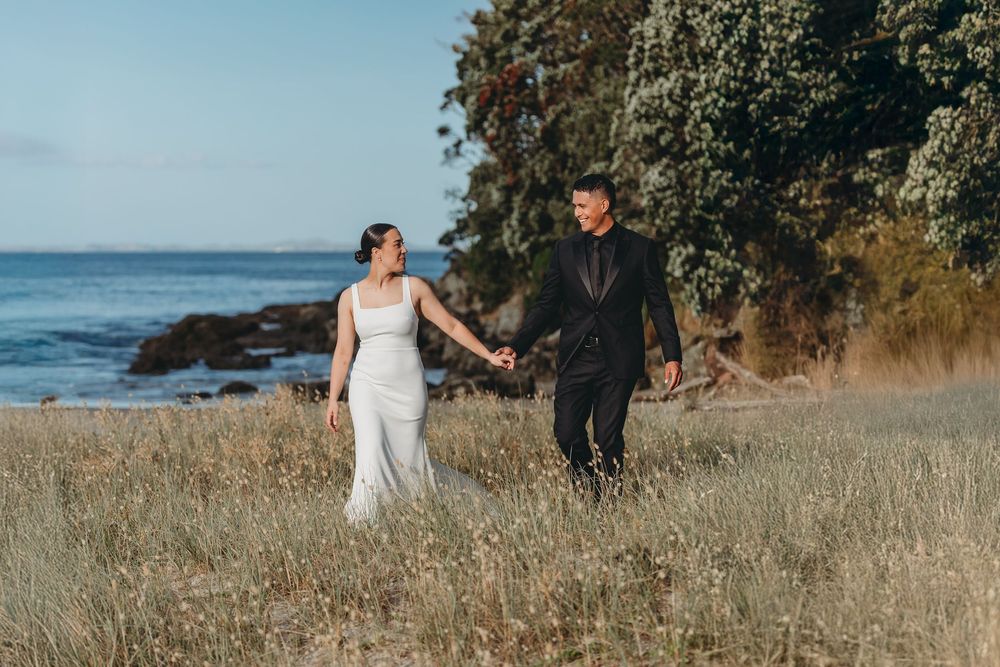 Ash and Tyran in the dunes at whangapoua on their wedding day