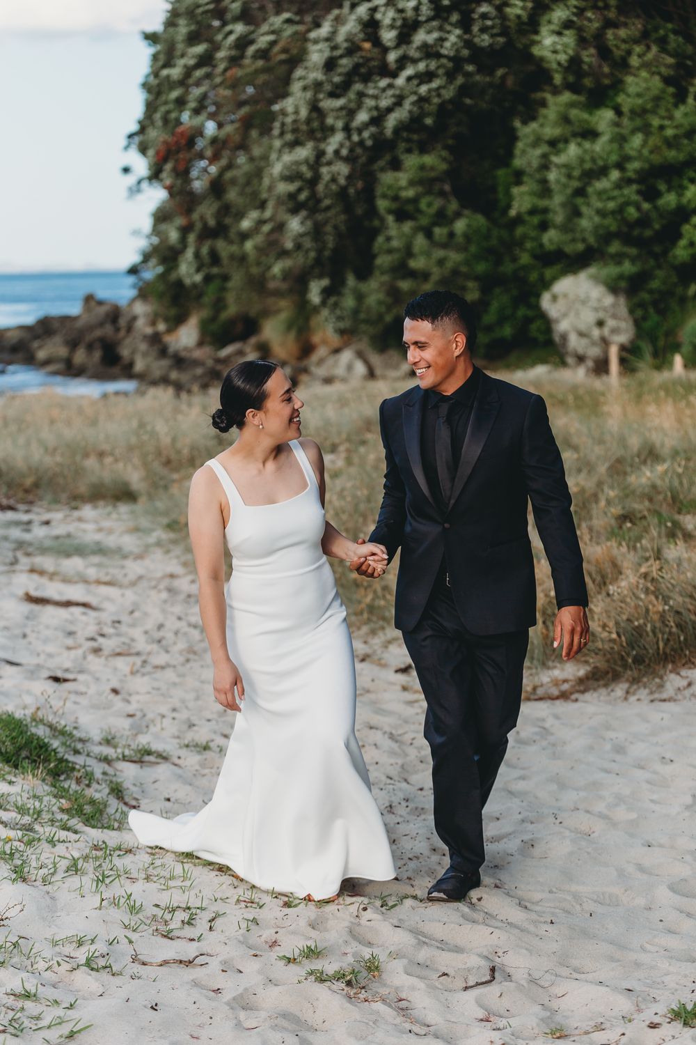 bride and groom in the dunes at whangapoua on their wedding day