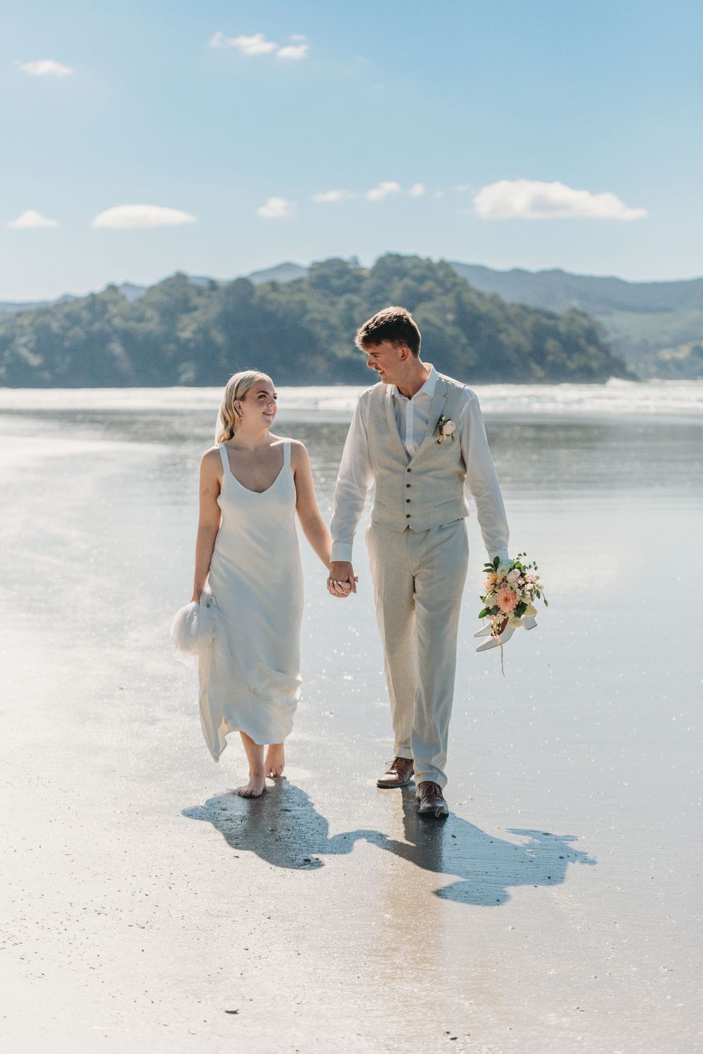 Josh and Libby on the beach at their wedding in Matarangi