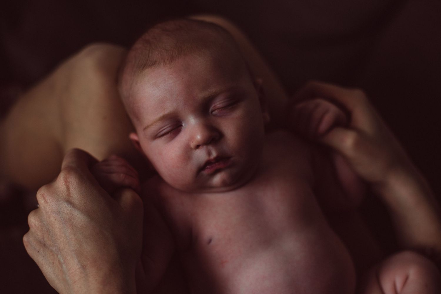 Newborn Photography London Prices for fine art photoshoot with woman laying on couch exposing pregnant belly