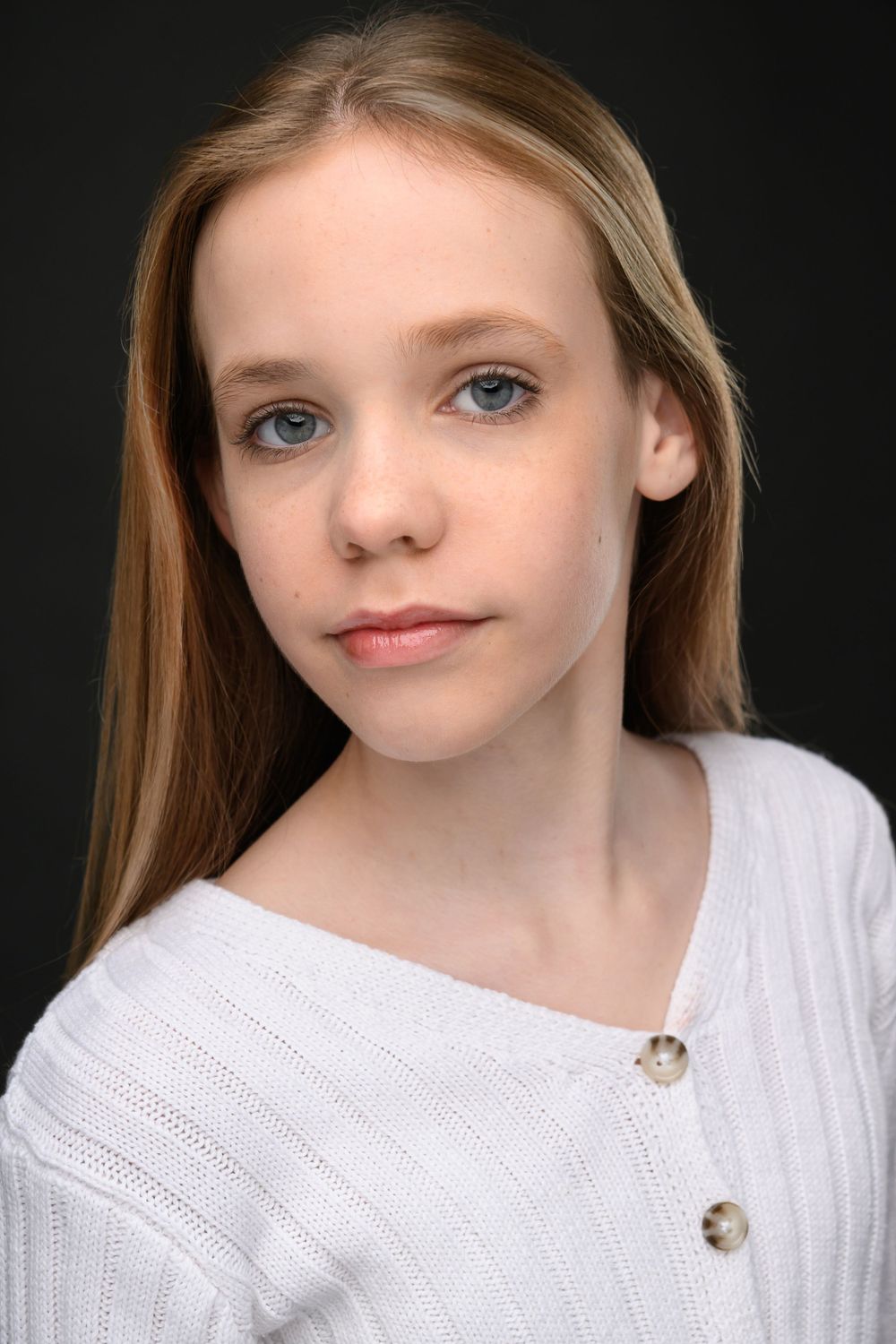 Close-up portrait series of someone in a white knit sweater against a dark background.