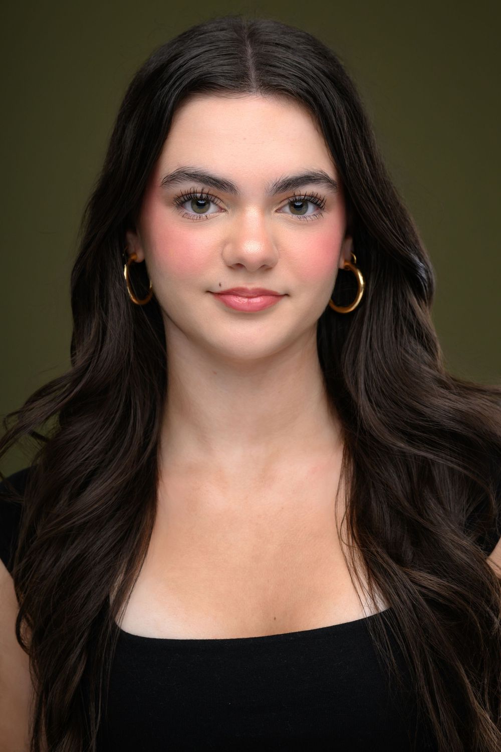 Close-up portrait series in black top against dark green background.