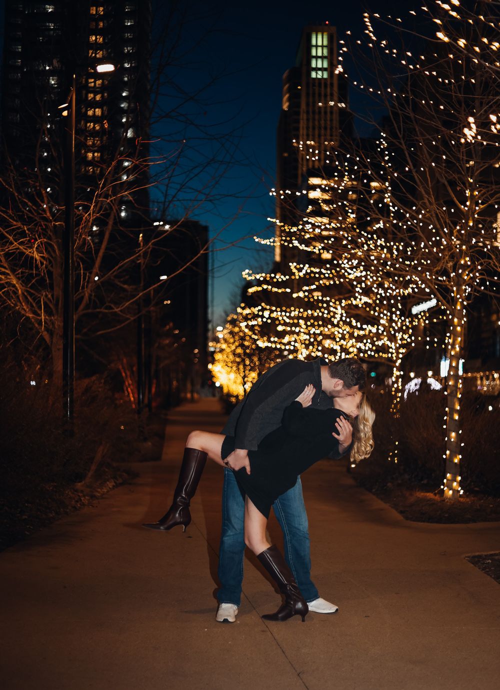 Romantic evening scene with string lights illuminating a pathway between buildings. Example of couples photography