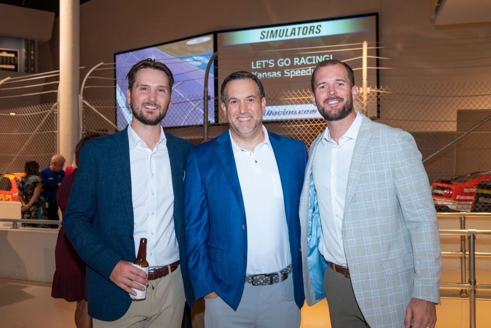 A group of men in business attire pose together at various corporate networking events and gatherings.