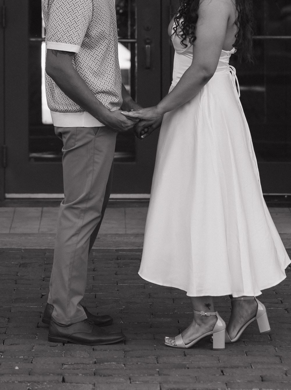 Five black and white photos showing the feet and lower legs of a couple dancing, with the bride in a white dress.