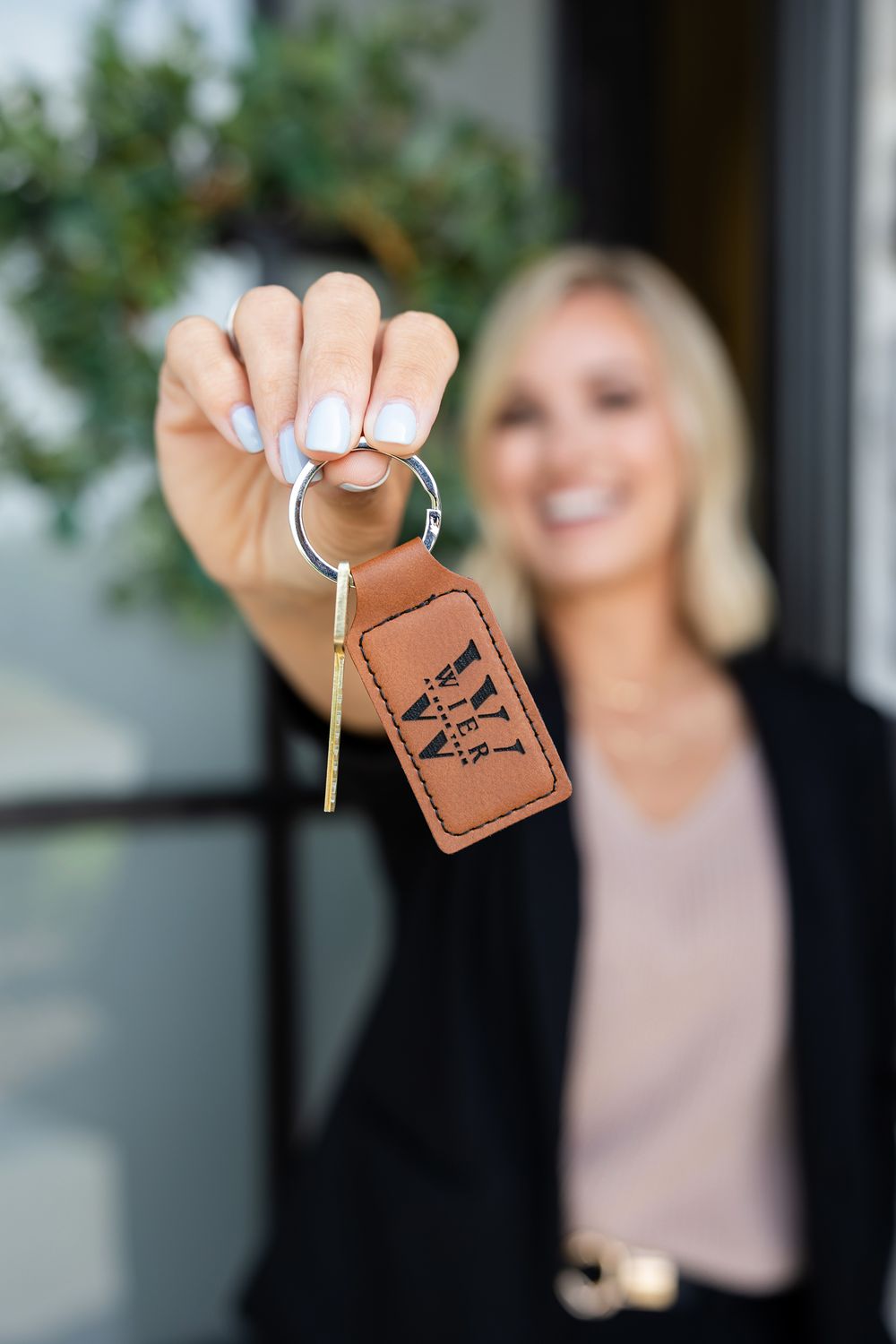 Central Missouri Real Estate Natalie Wier realtor holds keys to new home.