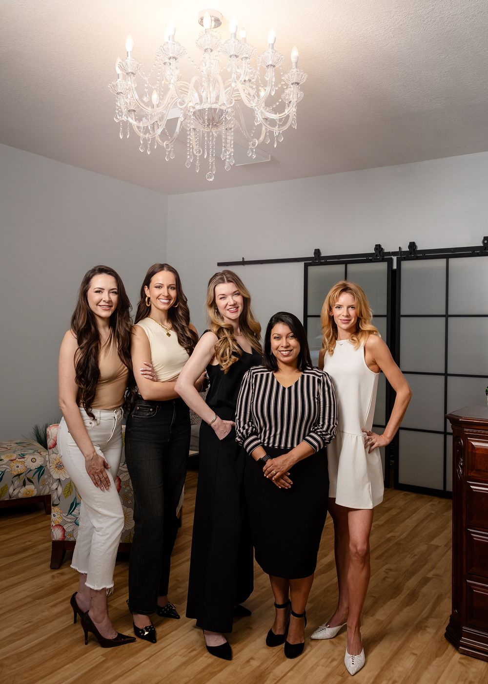 The all woman staff at Lumia med spa poses for a team portrait in their beautiful Columbia, MO office lobby.