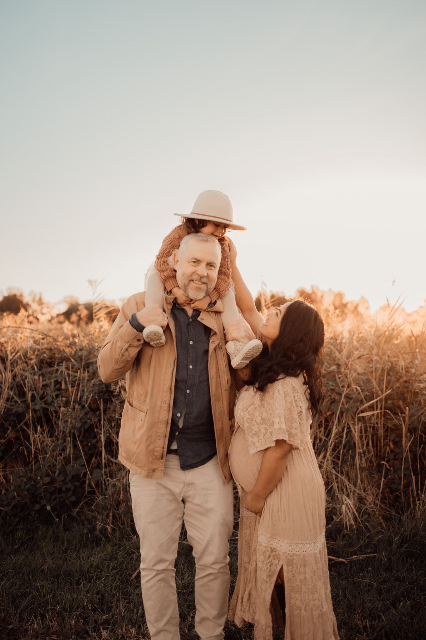 Golden hour family & maternity photography capturing love, connection & anticipation. Warm, timeless moments. Book your session today!