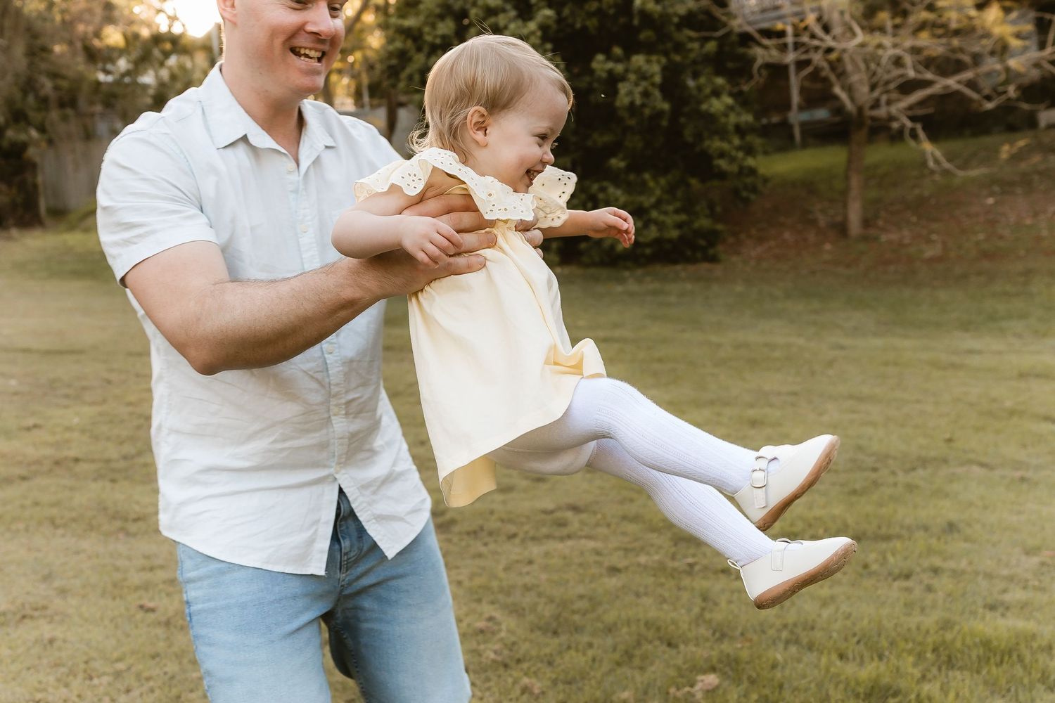 Family of four walking and laughing during family photo shoot at Brisbane outdoor location