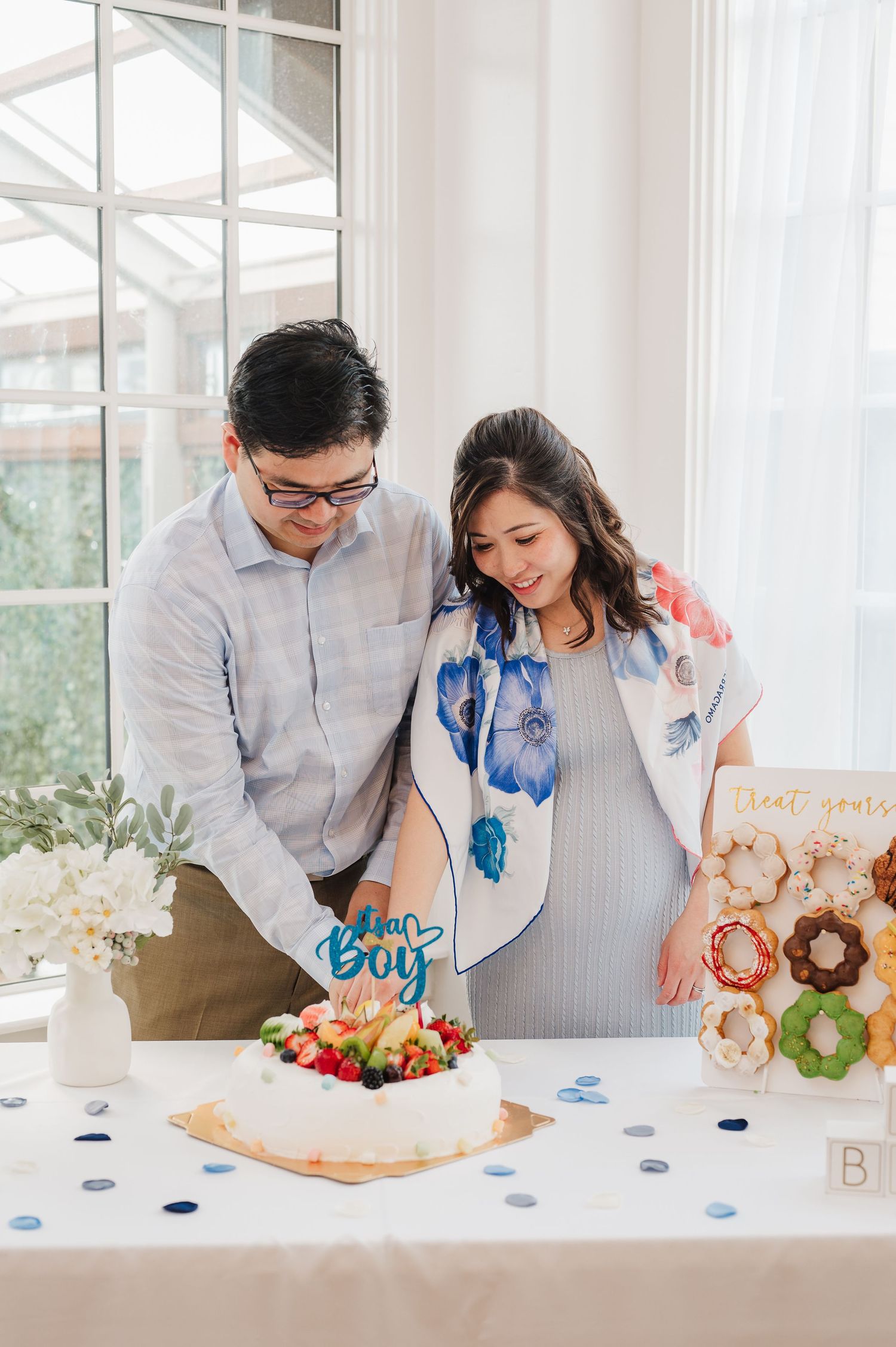 expecting parents at their baby shower standing next to the desert table in houston texas. best event photographer near me