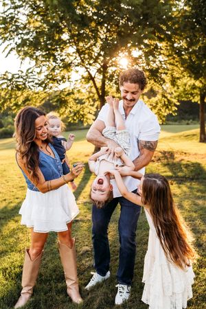 A family tickles the youngest sibling in Naugatuck State Park in Connecticut in the fall