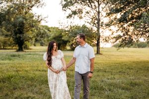A couple walks during a maternity session near Wallingford, CT in Autumn