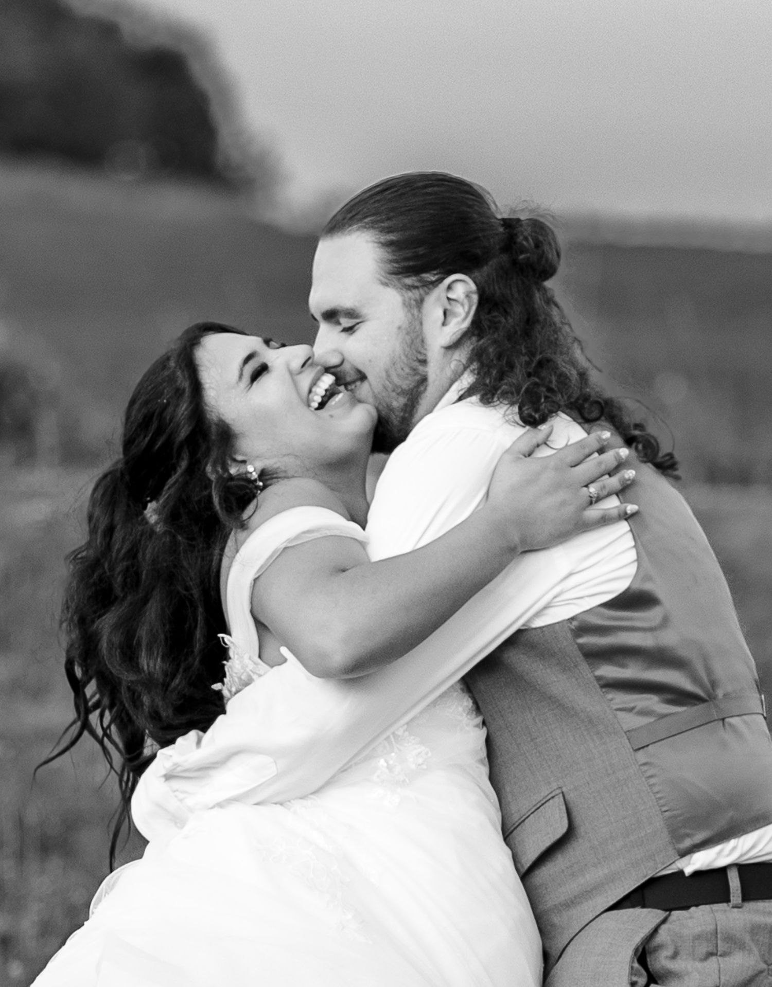 A romantic black and white wedding photo series showing a couple embracing and kissing in five intimate poses.