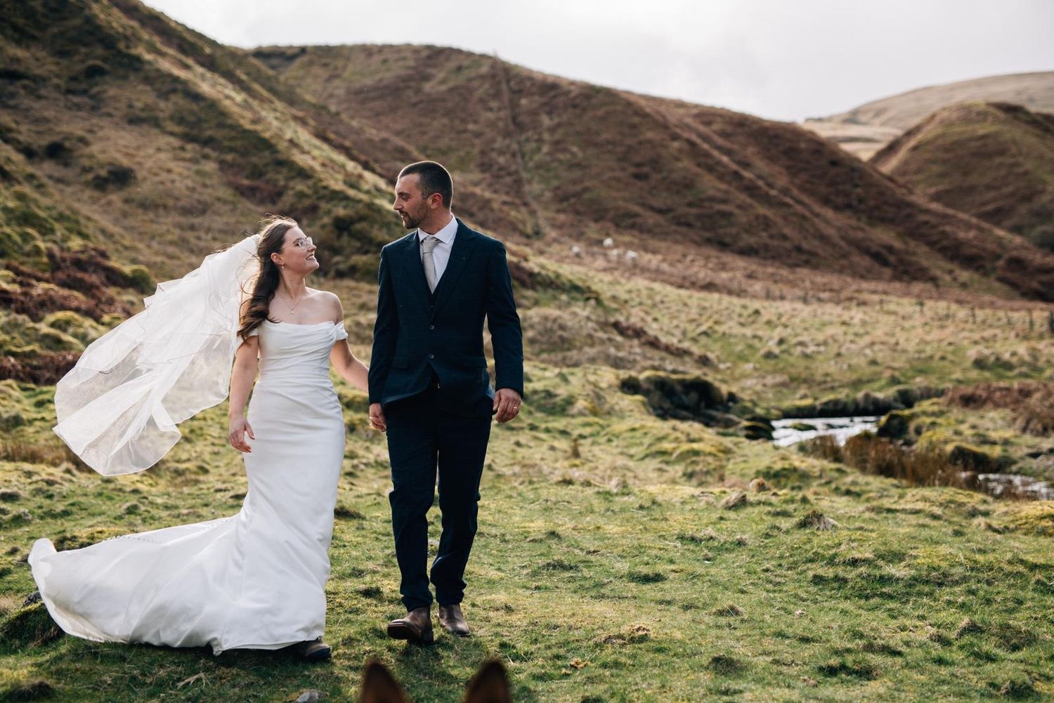 Couple shares intimate autumn moment with golden foliage in background.