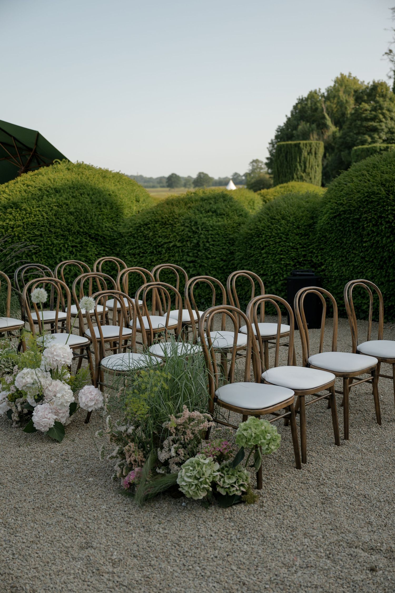 A romantic wedding couple shares an intimate moment in soft sunlit glow.