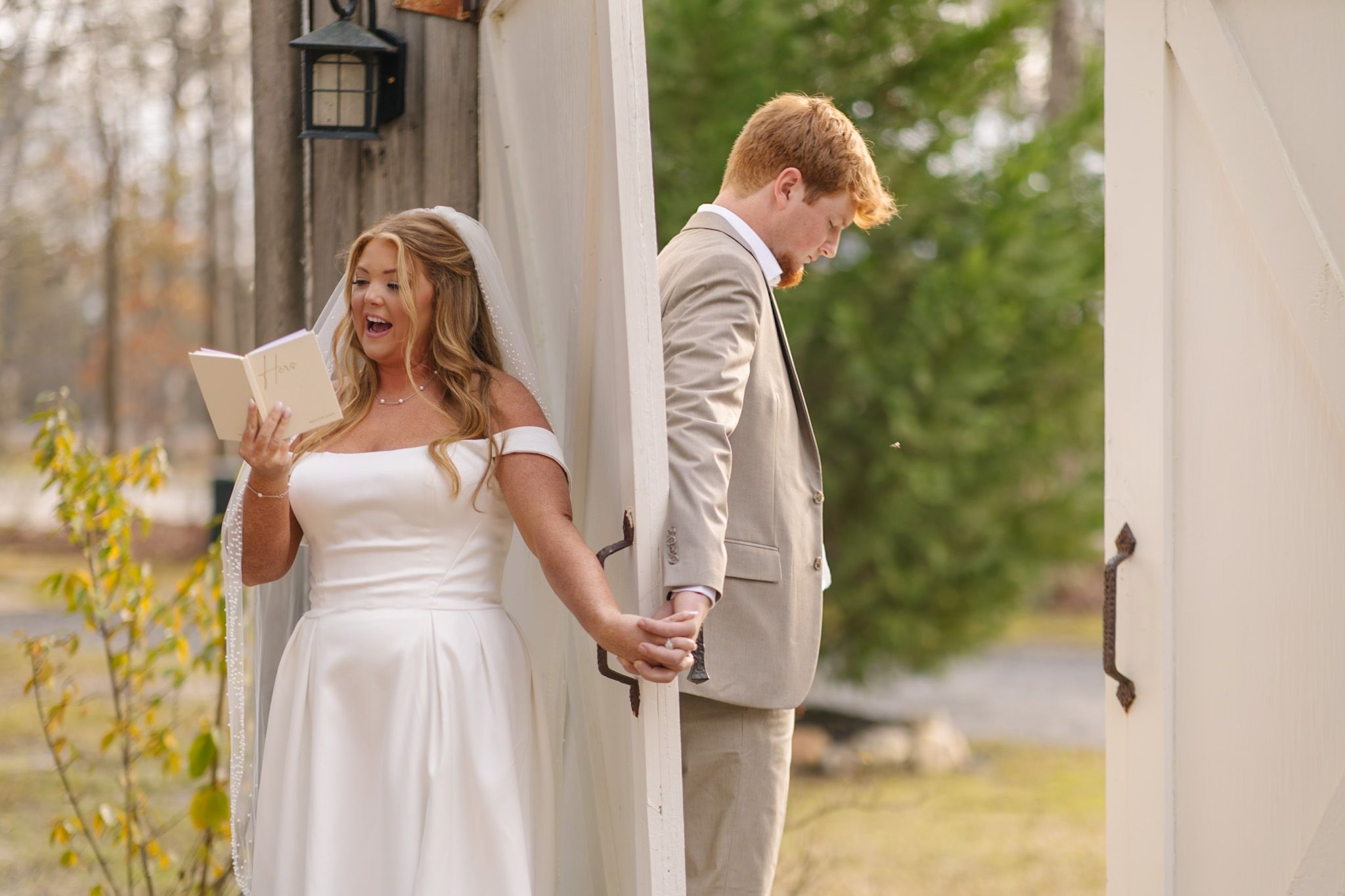 A couple shares a joyful moment together during their outdoor wedding ceremony in spring.