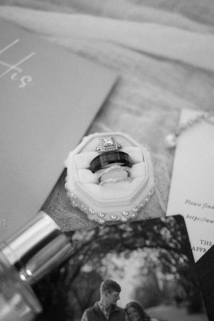 A collection of grayscale wedding photos showing rings, flowers, and decorative details in a soft, romantic style.