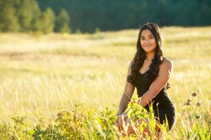 Sunny outdoor portrait in golden mountain meadow during sunset.