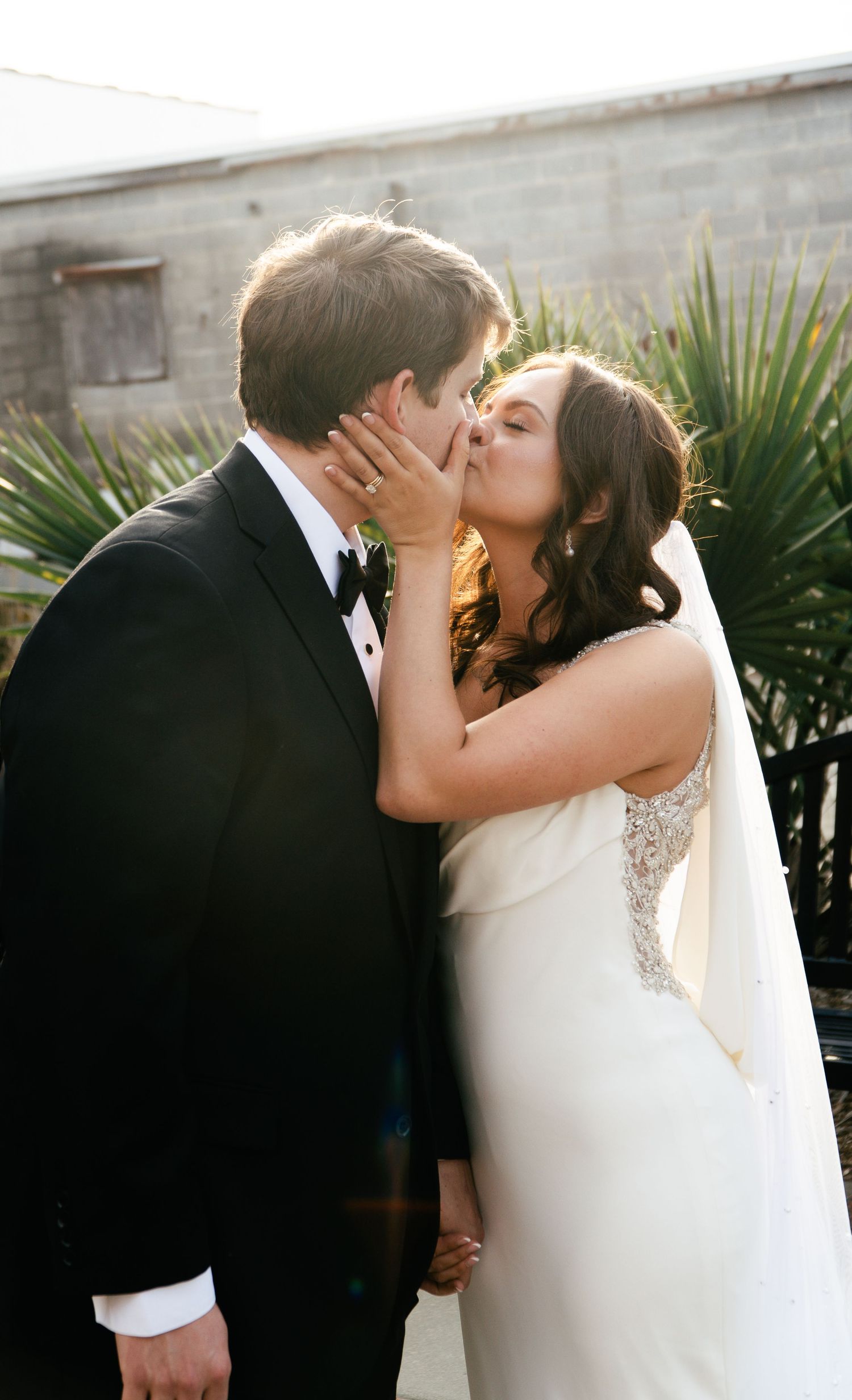 A sequence of romantic wedding photos showing a couple sharing a tender kiss in elegant formal attire.