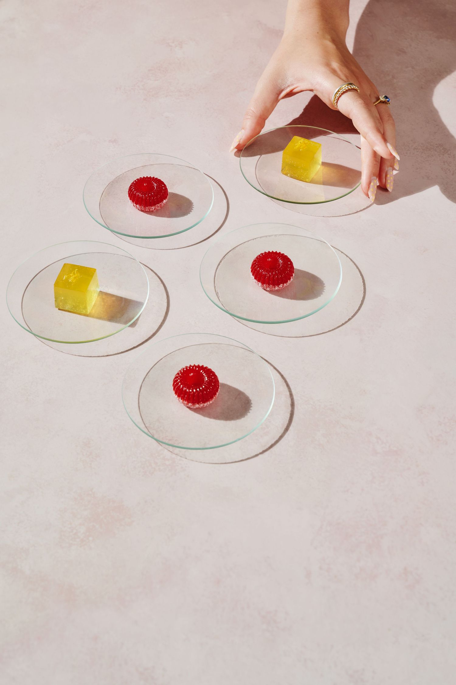 Glass plates with vibrant red and yellow jelly sweets Aggie Bea Commercial food and drink photographer elegant fine dining dessert dorset