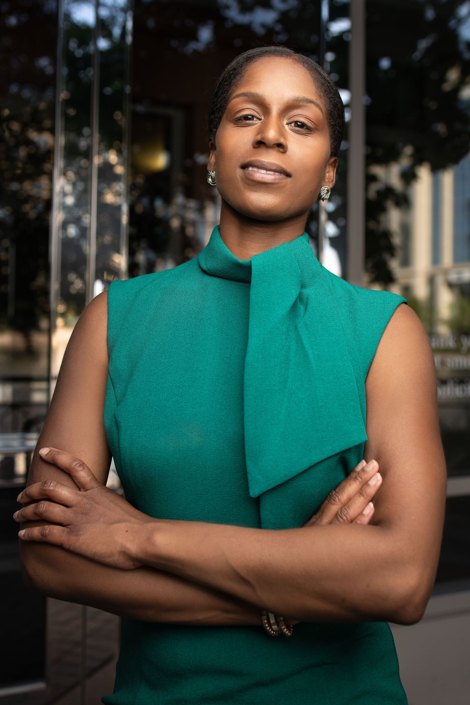 Professional businesswoman in a tailored suit, smiling confidently against, ideal for corporate headshot
