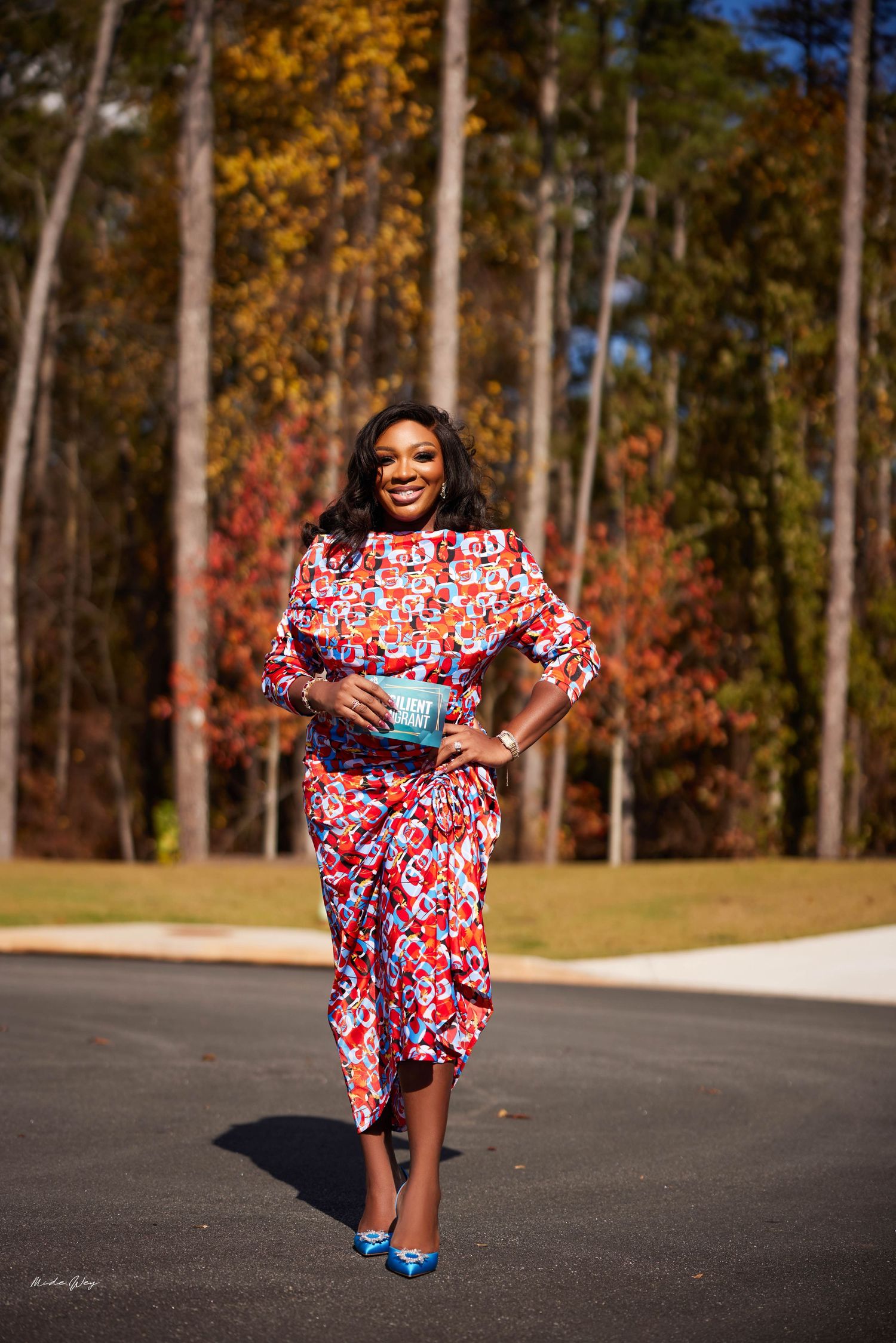 A series of five connected photos showing someone in a red floral dress posing playfully outdoors in autumn.