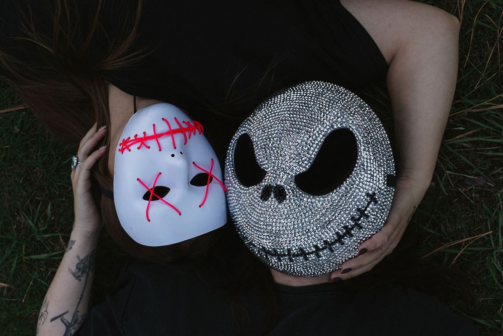 Painted Halloween pumpkins featuring spooky designs of Jack Skellington and Sally inspired by Nightmare Before Christmas.
