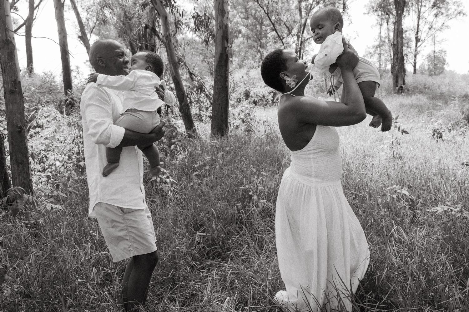 Black and white capture of family interactions in a natural outdoor setting.