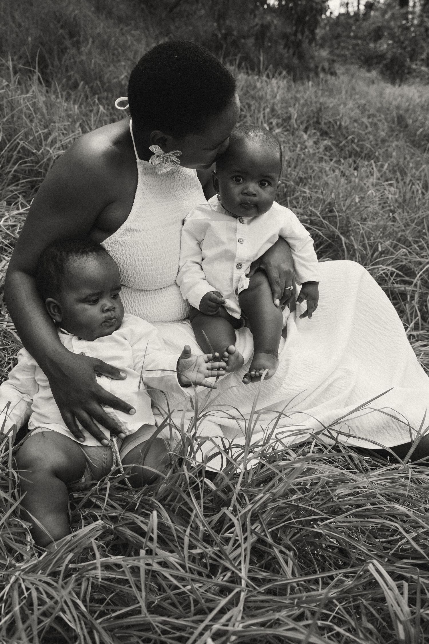 Black and white image of a family moment captured in an outdoor setting.