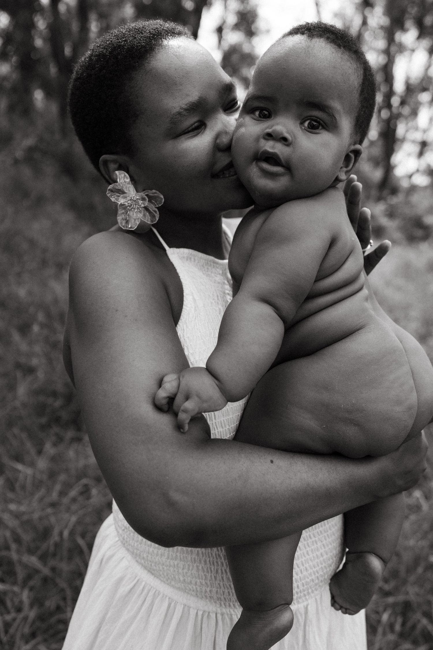 Loving embrace captured in black and white photography outdoors.