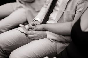 Close-up shot of smartphones being held in hands during informal gathering.