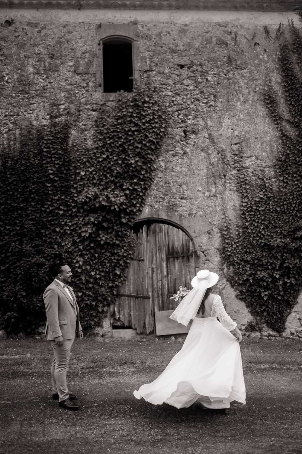 Black and white series of newlyweds playfully falling onto grass during outdoor wedding photoshoot.