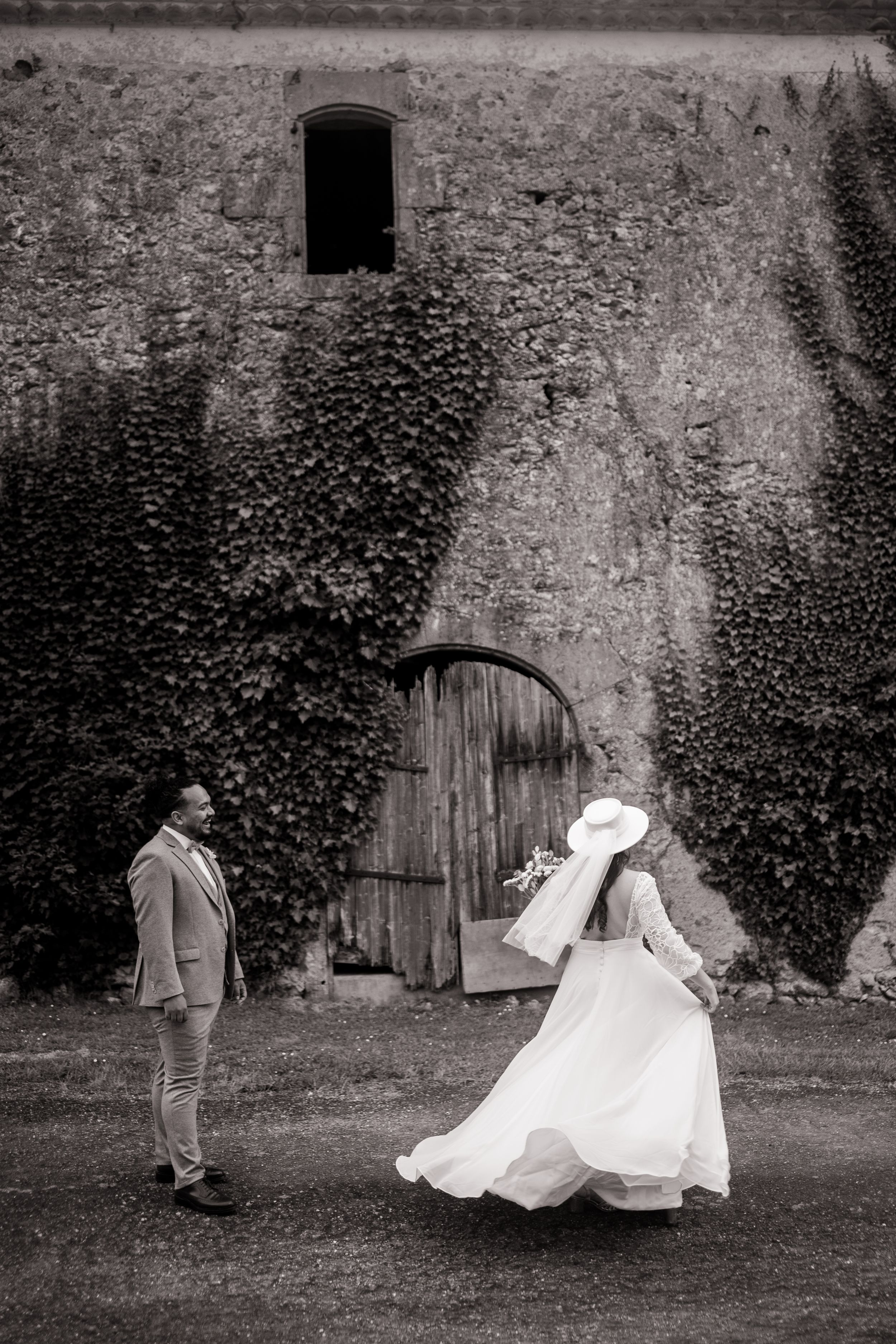Black and white series of newlyweds playfully falling onto grass during outdoor wedding photoshoot.