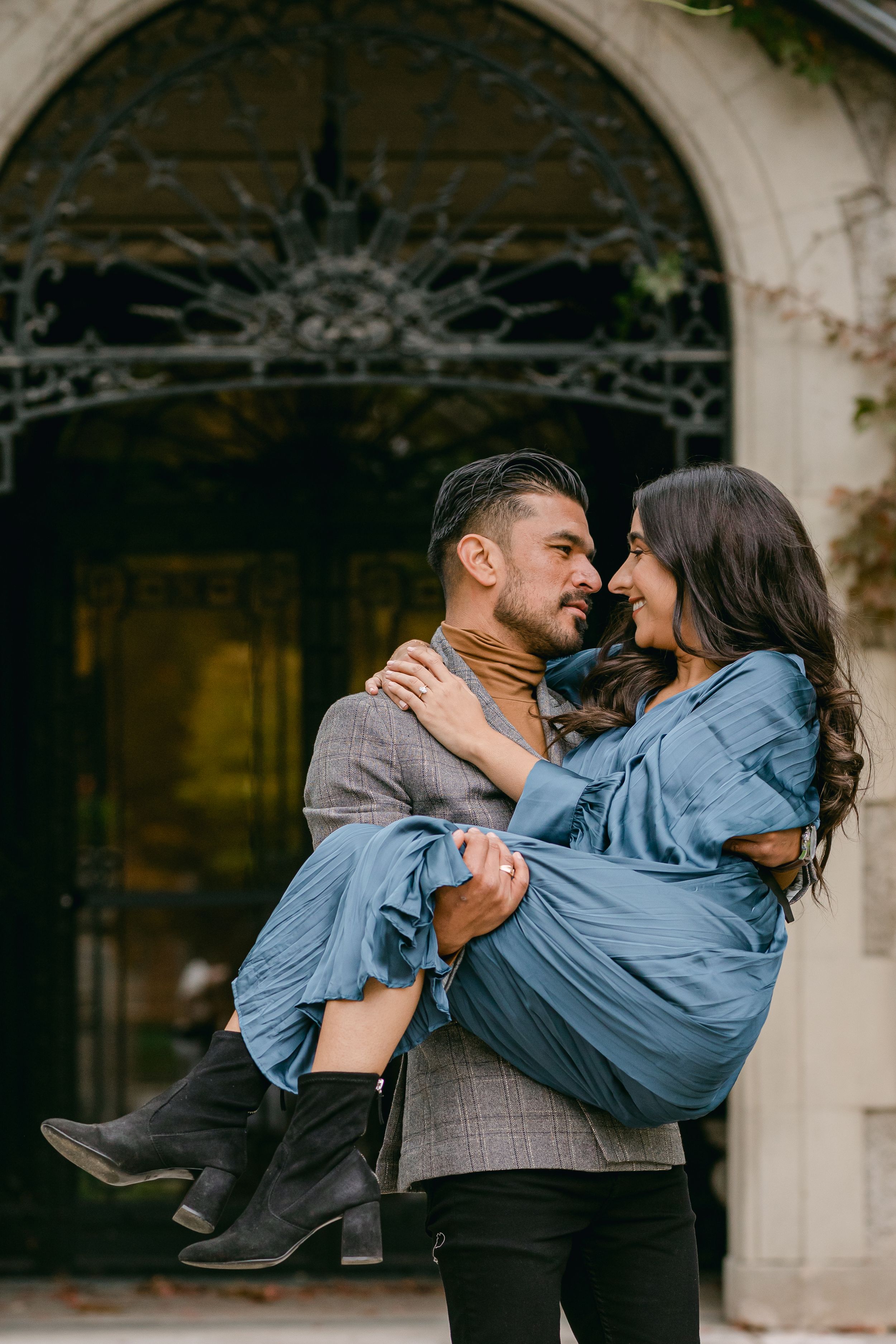 Romantic couple sequence showing playful lifts and embraces against stone archway.