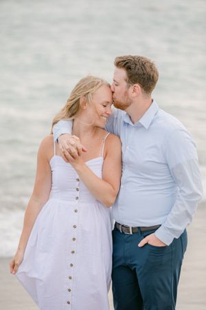 Romantic beach photoshoot sequence with couple in light summer attire.