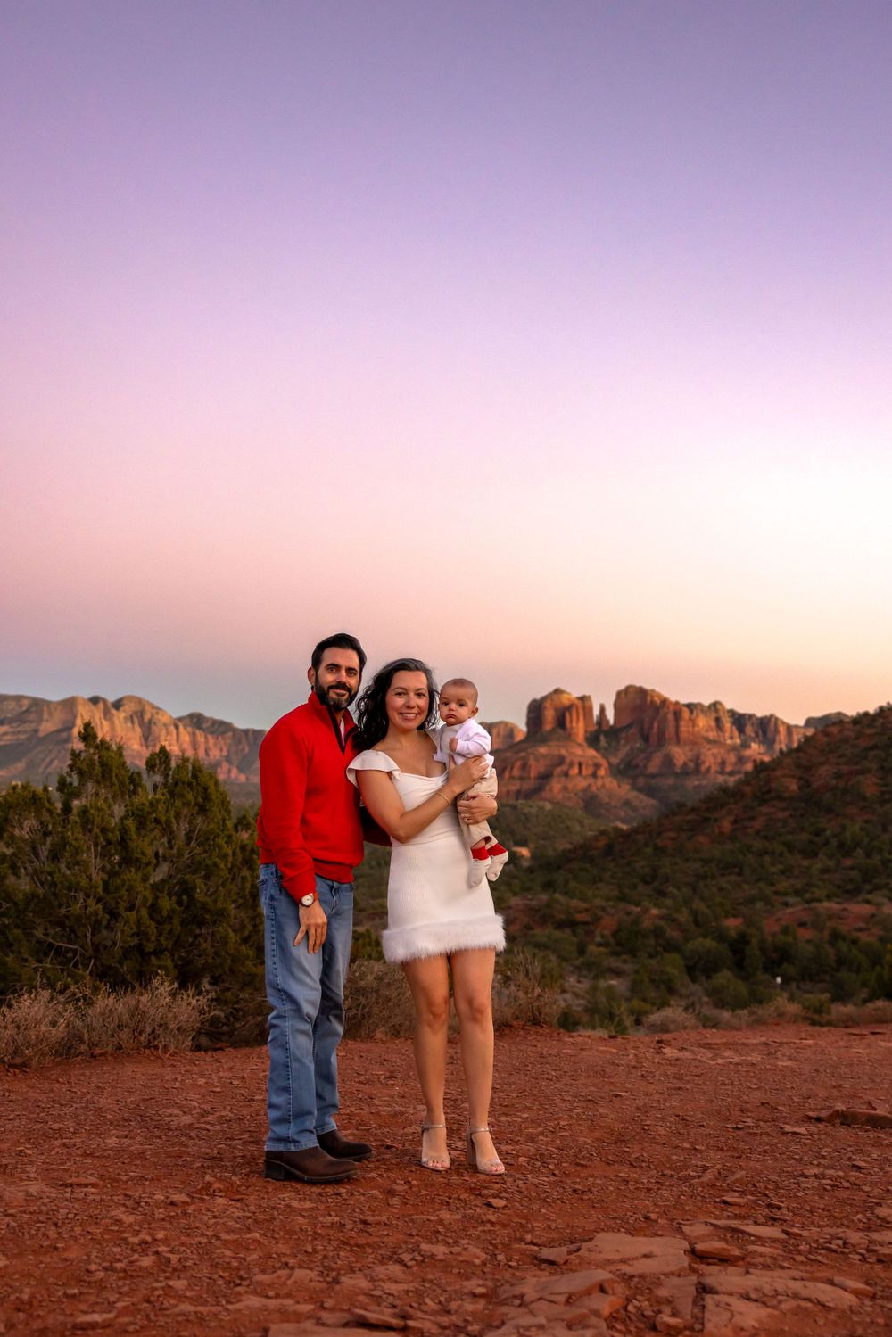 A scenic family photo at sunset overlooking the red rock formations in Sedona, Arizona. Sedona Family Portrait Photography