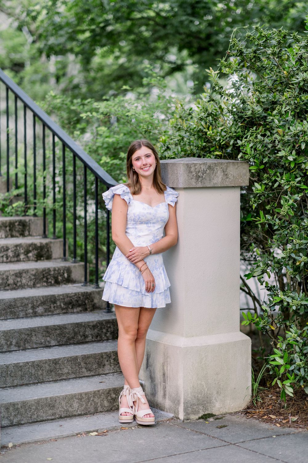 Casual outdoor photos by concrete steps with lush garden landscaping.