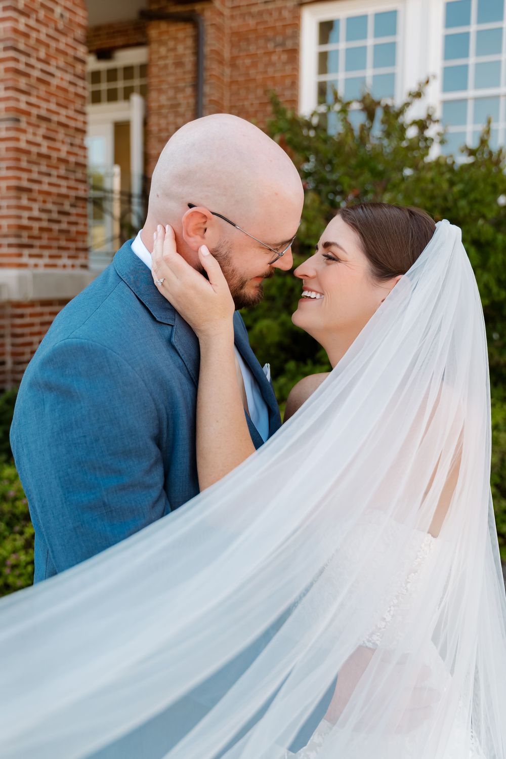 A romantic wedding moment captured in a series of four photos showing a couple embracing against a brick building backdrop.